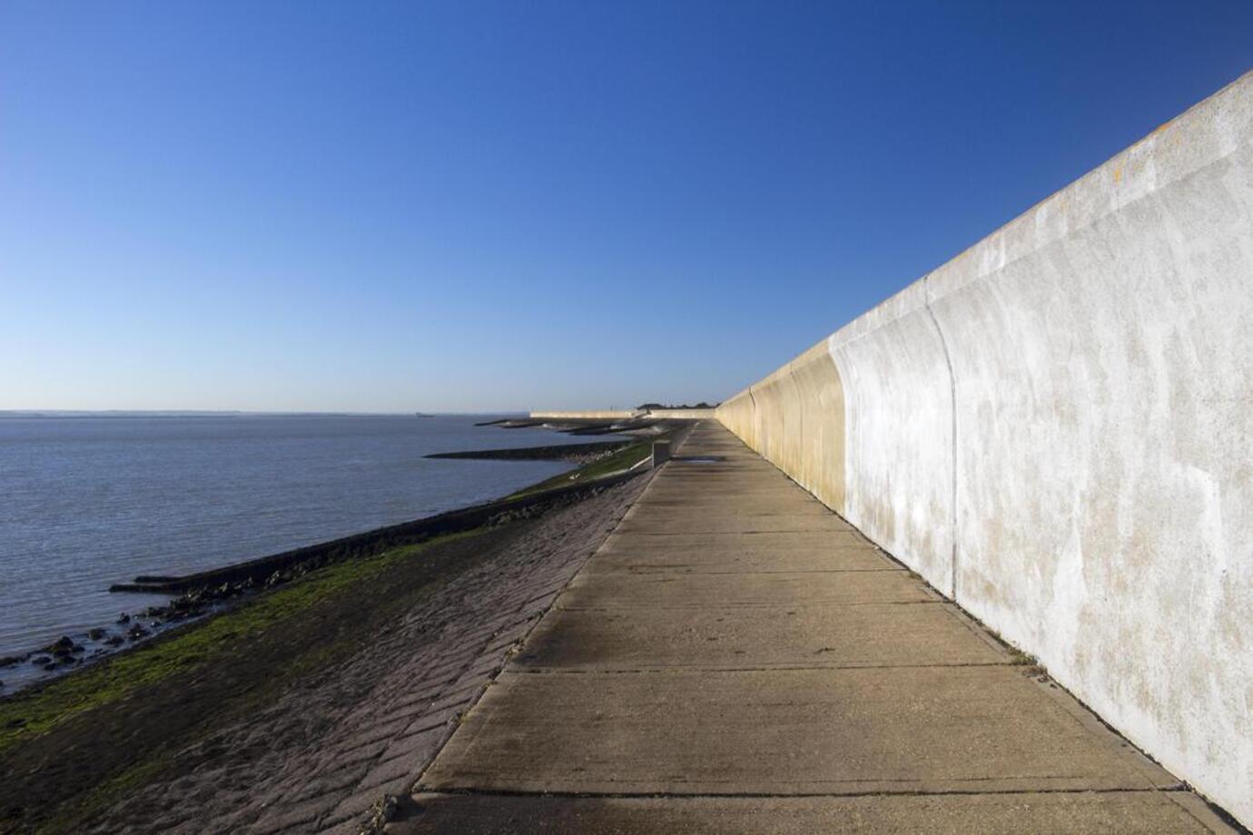 Canvey Island, Essex, sea, walk way and high wall. Location for solar panel installation and EV chargers from More than Solar Panels