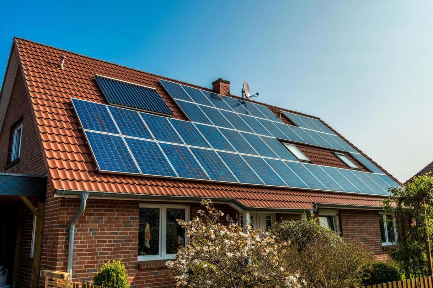 House with roof showing solar panels. More than solar panel blog image for South Benfleet area page. Installers of solar panels, EV chargers, air con, air source heat pumps and solar battery storage systems across Essex, London and Kent.